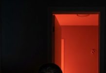 Every night, my neighbor left her door slightly ajar, acting strangely — so I positioned a hidden camera across the street.