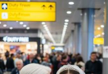 While checking in for my flight, a man beside me whispered, “When you arrive, avoid the main doors—take the maintenance exit instead